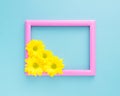 Empty pink frame with yellow flowers on blue background floral composition Royalty Free Stock Photo