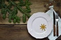 Empty pink plate, glass, cutlery, decorations on wooden background. Christmas table setting captured from above. Top view, flat Royalty Free Stock Photo