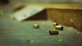 Empty pistol bullet shells on wooden table in a shooting range