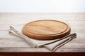 Empty pizza board and napkin on white wooden.