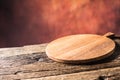 Empty pizza round board old wooden table and colour blurred bac