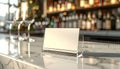 Empty Place Card on Bar Counter with Blurred Bottles and Glasses Royalty Free Stock Photo
