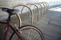 Empty place for a parking of bicycles under the apartment in metal rack