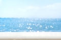 Empty plank white wood table top with blur blue sky and sea boekh background,summer holiday backdrop.Mock up template for display