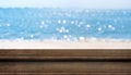 Empty plank wood table top with blur blue sky and sea boekh back