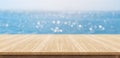 Empty plank wood table top with blur blue sky and sea boekh back