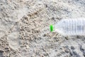 Empty plastic bottle on the beach. Trash garbage from human is empty beverage packages thrown away at the seaside. Royalty Free Stock Photo