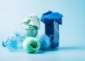 Empty plastic bottle and various fabrics made of recycled polyester fiber synthetic fabric on a blue background Royalty Free Stock Photo