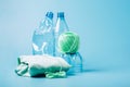 Empty plastic bottle and various fabrics made of recycled polyester fiber synthetic fabric on a blue background Royalty Free Stock Photo