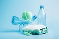 Empty plastic bottle and various fabrics made of recycled polyester fiber synthetic fabric on a blue background Royalty Free Stock Photo
