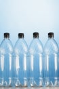 Empty plastic bottles on blue background Royalty Free Stock Photo