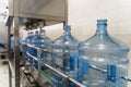 Empty plastic bottles or gallons on conveyor belt machinery equipment in pure water production factory Royalty Free Stock Photo