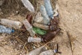 Empty plastic bottles on the sand. Garbage on the beach. Dirty sea shore. Environmental pollution. Royalty Free Stock Photo