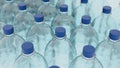 Empty plastic clean bottles for water with caps lids. Production of plastic bottles for water, isolate. 3d render Royalty Free Stock Photo