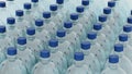 Empty plastic clean bottles for water with caps lids. Production of plastic bottles for water, isolate. 3d render Royalty Free Stock Photo