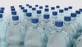 Empty plastic clean bottles for water with caps lids. Production of plastic bottles for water, isolate. 3d render Royalty Free Stock Photo