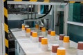 Empty plastic cups moving on conveyor belt at package exhibition