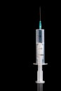 empty plastic medical syringe with a needle on a black background, copy space Royalty Free Stock Photo