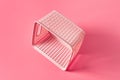 Empty plastic square basket with handles for washing for keeping clear or messy clothes at home or laundry lies on pink countertop Royalty Free Stock Photo