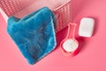 Empty plastic square basket for washing with blue soft towel near antibacterial soap and measuring spoon full of powder Royalty Free Stock Photo