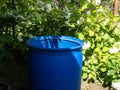 Empty, plastic water barrel prepared to be reused for collecting and storing rainwater for watering plants