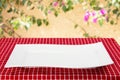 Empty plate background. Empty white plate on table with red napkin or tablecloth over yellow wall with flowers. Template for your Royalty Free Stock Photo