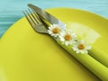 Empty plate rustic on a blue wooden background menu daisy flower fork, knife Royalty Free Stock Photo