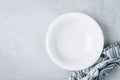 Empty plate or bowl with linen napkin on gray stone concrete background Royalty Free Stock Photo