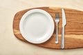 Empty plate and chopping board on table. Top view.