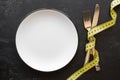 Empty plate with cutlery and measuring tape concept diet Royalty Free Stock Photo