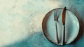 Rustic Plate with Fork and Knife on Textured Background Royalty Free Stock Photo
