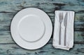 Empty plate and cutlery on used look wood