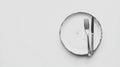 Minimalist Plate and Cutlery on White Background - Table Setting Concept Royalty Free Stock Photo