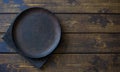 Empty plate on a dark natural wooden background