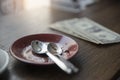 Empty plate dirty plate with cake after eating with dollar money,place on wooden table in coffee shop.Check bill and and tip Royalty Free Stock Photo