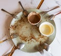 Top view of empty plate with spoons and forks, dirty after dessert meal is finished Royalty Free Stock Photo