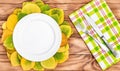 Empty plate with fork, knife and autumn leaves on wooden table. Top view Royalty Free Stock Photo