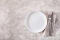 Empty plate fork knife on concrete background Royalty Free Stock Photo