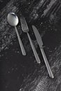 Abstract image of knife, spoon and fork on dark background Royalty Free Stock Photo