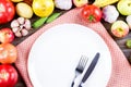 Empty plate with fork and knife surrounded with fresh vegetables, healthy eating concept