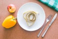 Empty plate, fork, knife and tape measure on wooden table Royalty Free Stock Photo