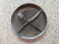 an empty plate left after dessert, a knife and a fork crossed Royalty Free Stock Photo