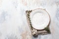 Empty plate, linen napkin and eucalyptus branches, light concrete background. Spring menu concept. Trendy minimal style tableware Royalty Free Stock Photo