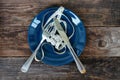Empty plate with measuring tape, knife and fork. Diet food Royalty Free Stock Photo