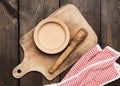 Empty plate and old brown rectangular wooden kitchen cutting board on the table Royalty Free Stock Photo