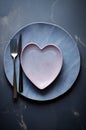 an empty plate with a pink heart on it and a fork and knife on the top Royalty Free Stock Photo