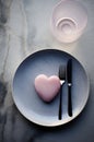 an empty plate with a pink heart on it and a fork and knife on the top Royalty Free Stock Photo