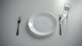 Empty plate served on table, glass with water, no money for food, poverty