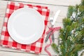 Empty plate, silverware and christmas tree Royalty Free Stock Photo