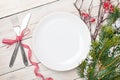 Empty plate, silverware and christmas tree Royalty Free Stock Photo